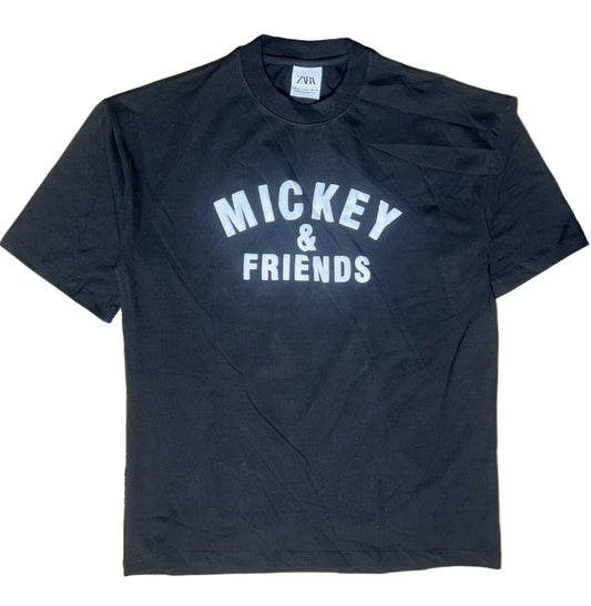 Black t-shirt with 'Mickey & Friends' text on a beige surface